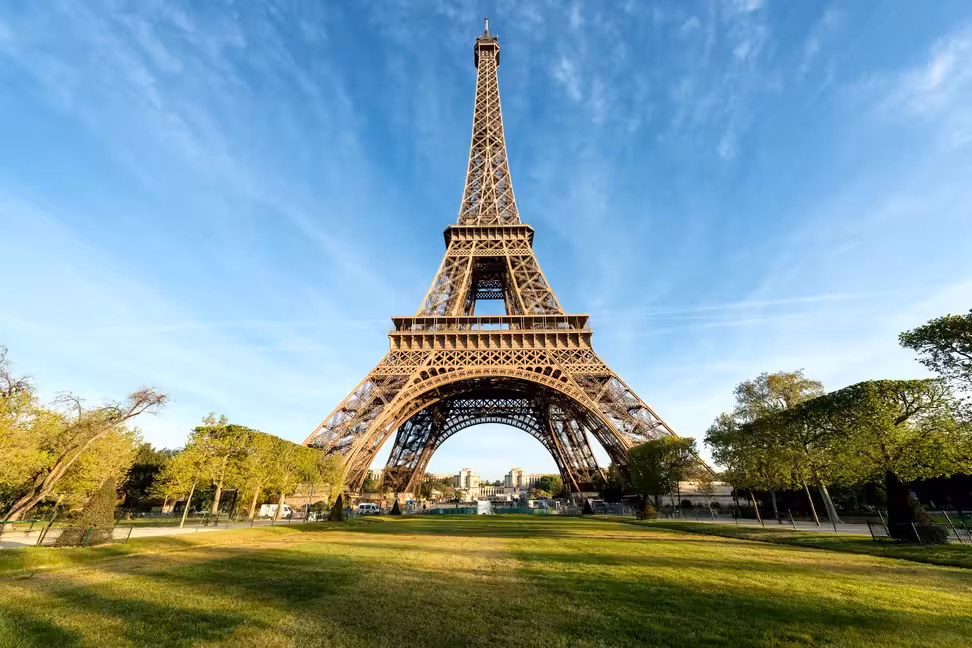 The Eiffel Tower from below, with its iron arches and the first and second floors