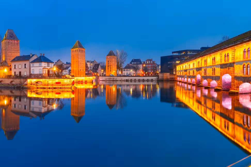 The Ponts Couverts and the Vauban Dam in Strasbourg, reflected in the Ill at dusk.