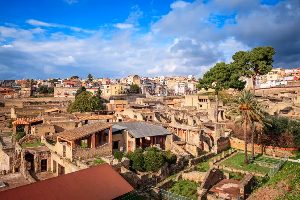 Roman houses in the ruins of Herculaneum, with the modern town of Ercolano behind.