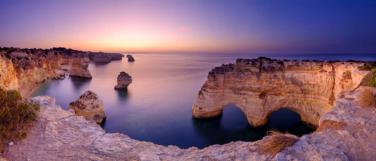 Praia da Marinha, considered one of Portugal's most beautiful beaches, showcases dramatic limestone cliffs, golden sands, and crystal-clear waters, making it a beloved destination for photography, snorkeling, and experiencing the Algarve's natural splendor.