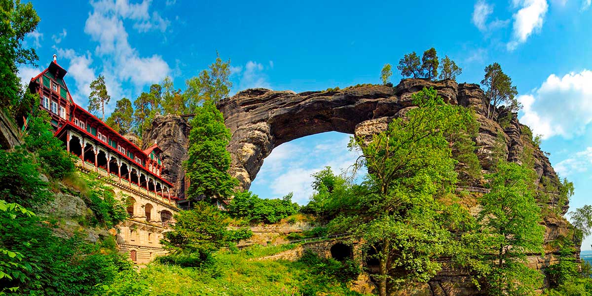 Pravčická Gate, a majestic natural sandstone arch in Bohemian Switzerland, Czech Republic, stands as Europe's largest natural rock bridge, showcasing dramatic rock formations and lush forest scenery, attracting hikers and nature enthusiasts.