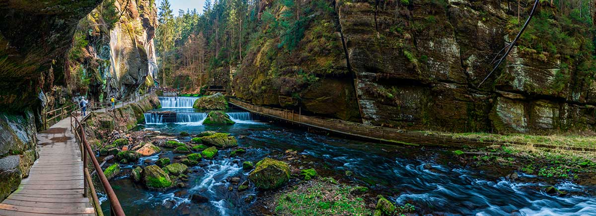 Bohemian Switzerland National Park, in the Czech Republic, offers breathtaking landscapes with sandstone rock formations, deep gorges, lush forests, and the iconic Pravčická Gate, making it a haven for hiking and nature photography.