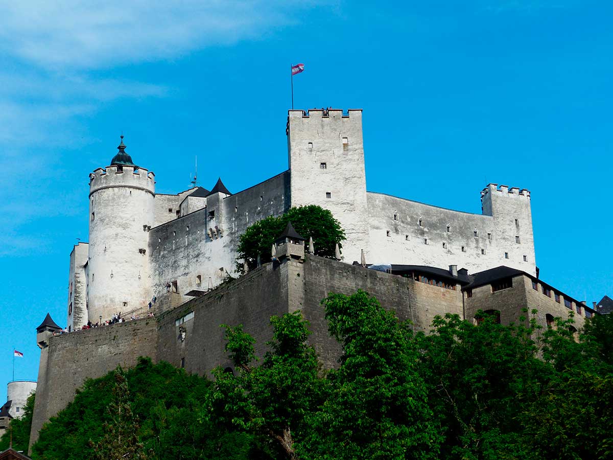 Hohensalzburg Fortress, a dominant medieval castle perched atop a Salzburg hill, offers panoramic views of the city, showcases historic architecture, and provides insights into the region's rich history and military significance.