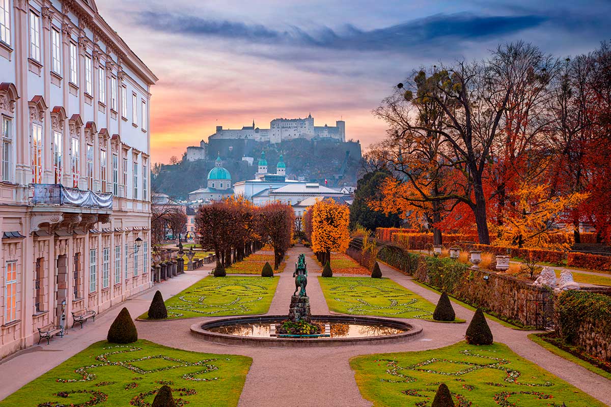 Mirabell Gardens, Salzburg, Austria, showcases vibrant floral displays, Baroque statues, and the Pegasus Fountain, framed by the backdrop of Hohensalzburg Fortress, offering a serene and visually stunning landscape for visitors.