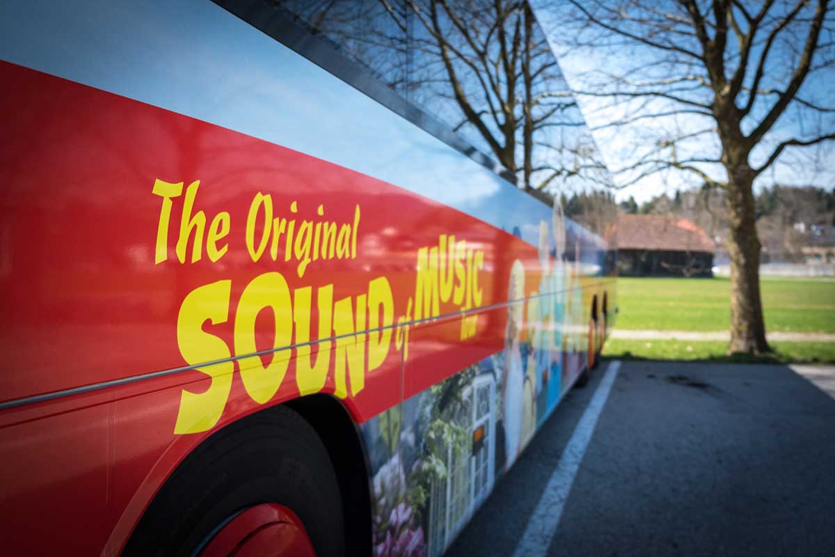 A "Sound of Music" tour bus in Salzburg, Austria, transports visitors to iconic film locations, showcasing the scenic landscapes and historical sites featured in the beloved musical, offering a nostalgic and entertaining experience.