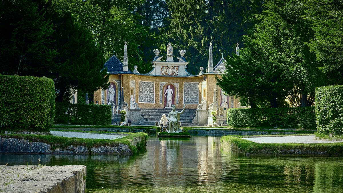 Hellbrunn Palace's trick fountains in Salzburg surprise visitors with hidden water jets, playful Baroque statues, and unexpected sprays, creating a whimsical and entertaining experience in a historic garden setting.