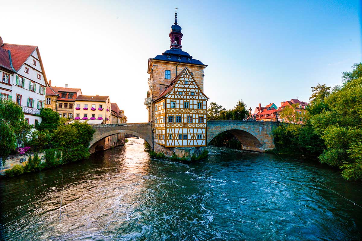 Bruges, a charming Belgian city, features picturesque canals, medieval architecture, including the Belfry of Bruges, and cobblestone streets, creating a fairytale-like atmosphere that attracts tourists seeking historic beauty.
