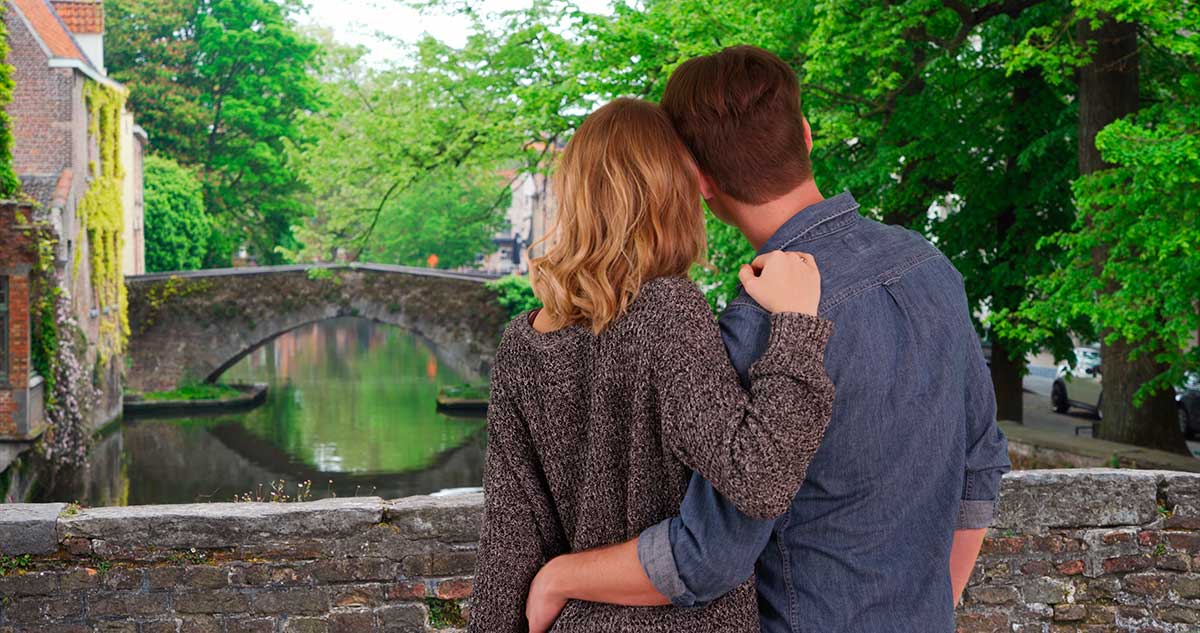 Romantic Bruges vacation, couple exploring canals