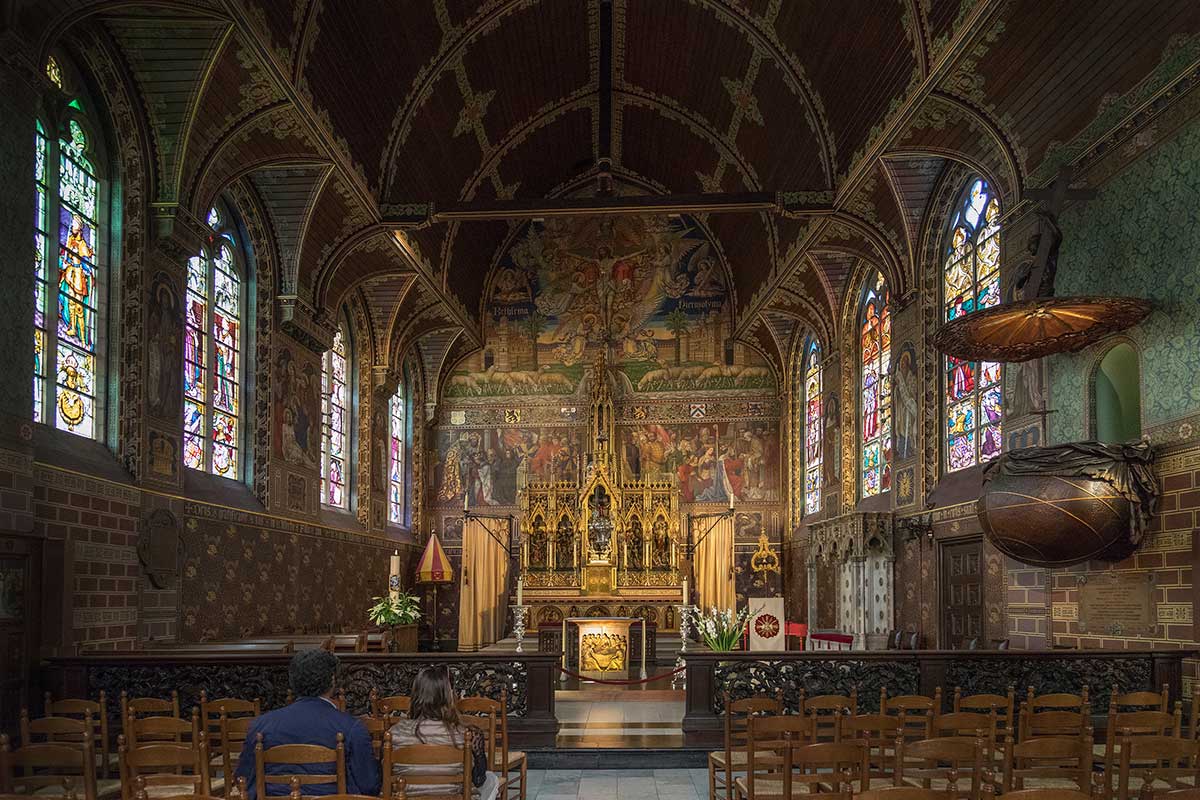 The Basilica of the Holy Blood in Bruges, Belgium, displays ornate Gothic architecture and houses a revered relic, believed to be a cloth containing the blood of Jesus Christ, attracting pilgrims and tourists to its historical and religious significance.