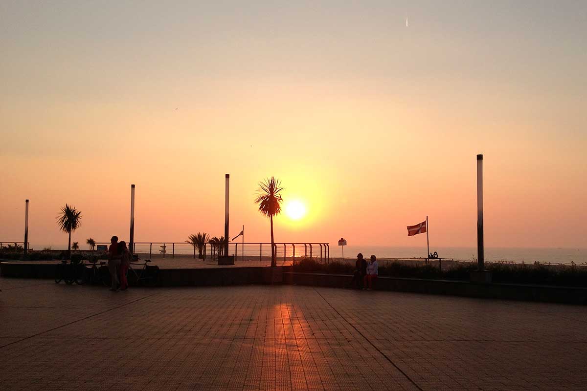 Ostend, a Belgian coastal city, features sandy beaches, a bustling harbor with fishing boats, the historic Mercator sailing ship, and modern seaside promenades, offering a blend of maritime heritage and contemporary resort attractions.