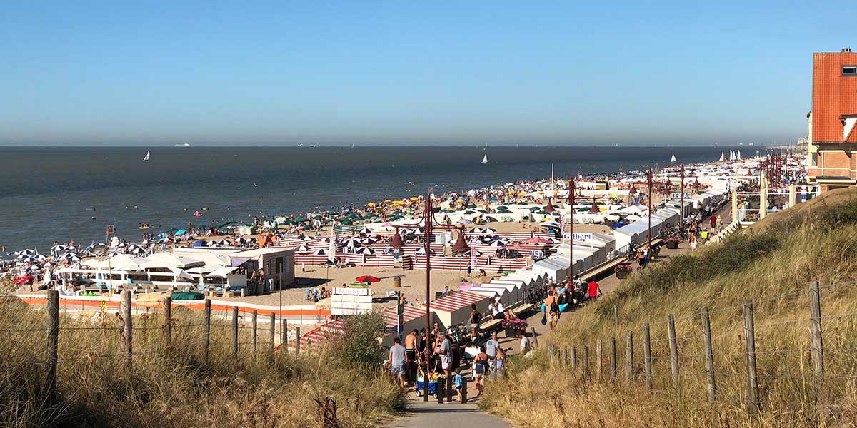 De Haan, a charming Belgian coastal town, features well-preserved Belle Époque villas, sandy beaches lined with dunes, and a tranquil atmosphere, offering a nostalgic seaside escape.