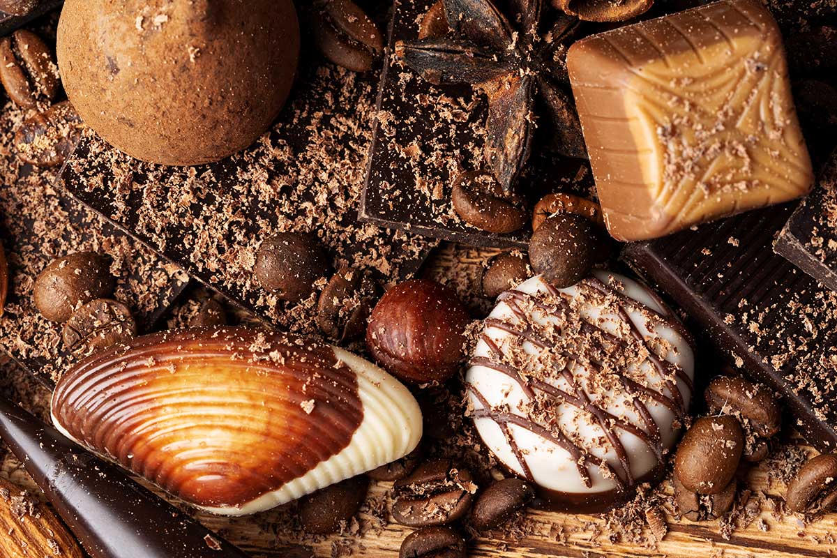 Belgian chocolate, known for its smooth texture and rich flavor, is often crafted into intricate pralines, truffles, and bars, showcasing the country's meticulous craftsmanship and high-quality ingredients.