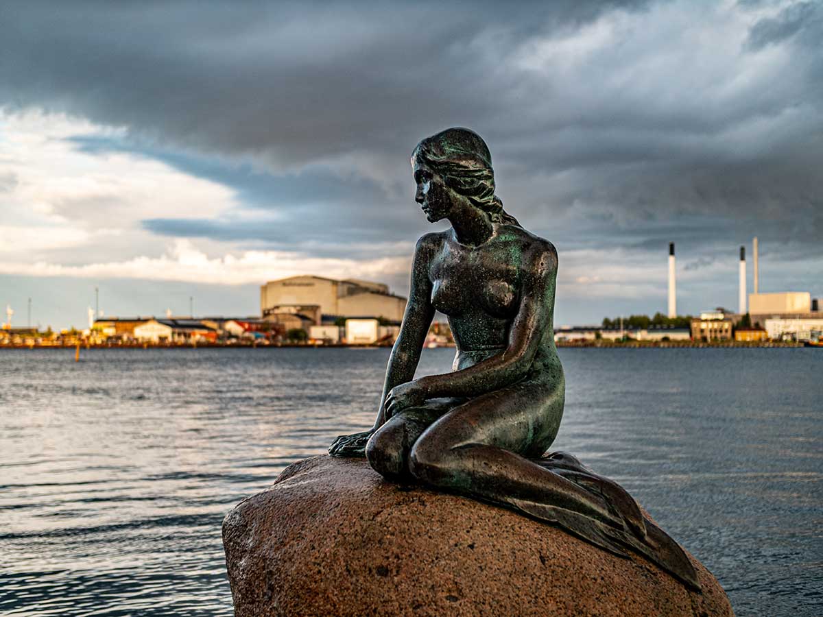 The Little Mermaid, a bronze statue in Copenhagen, Denmark, perched on a rock by the harbor, depicts Hans Christian Andersen's fairy tale character, symbolizing the city's literary heritage and becoming an iconic landmark.