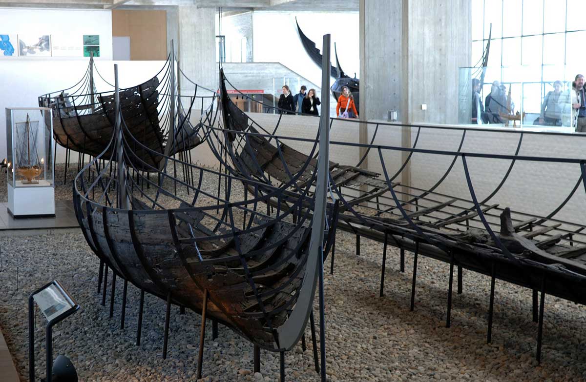 The Viking Ship Museum in Roskilde, Denmark, displays five recovered Viking ships, showcasing their shipbuilding techniques and maritime history, alongside interactive exhibits that explore Viking seafaring and cultural heritage.