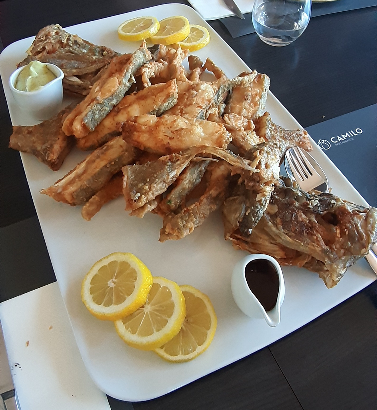Traditional Algarve dishes at Restaurante O Camilo, presented simply, reflecting the restaurant's focus on fresh ingredients and authentic flavors.