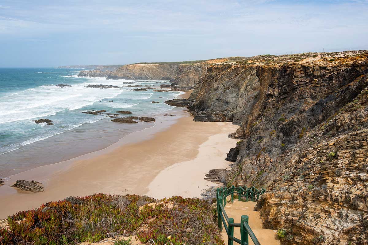 The Wild Vicentina Coast offers stunning, rugged landscapes, featuring dramatic cliffs, secluded beaches, and the renowned Rota Vicentina hiking trails, making it a prime destination for nature enthusiasts.