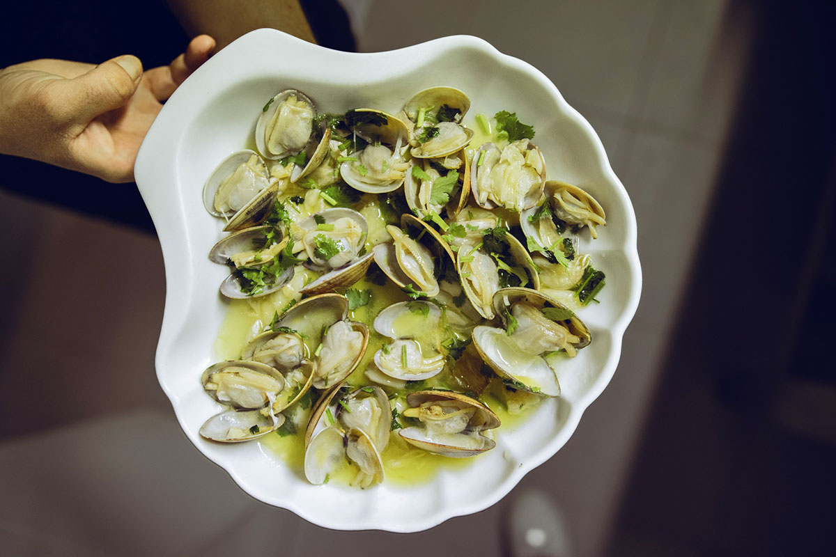 Savor the classic Portuguese delight, Amêijoas à Bulhão Pato, a simple yet exquisite dish of clams cooked in garlic, olive oil, and cilantro.