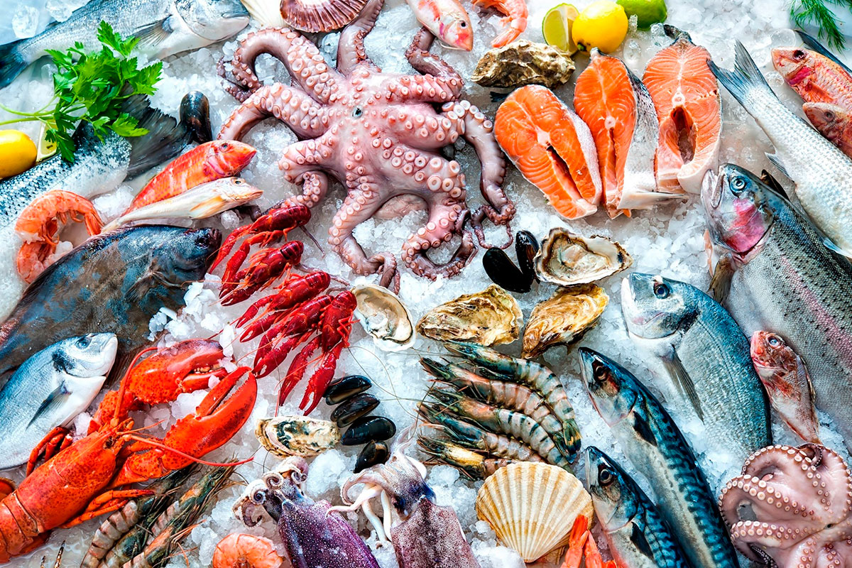 Fishmongers expertly prepare fish for customers, sharing cooking tips and local recipes.