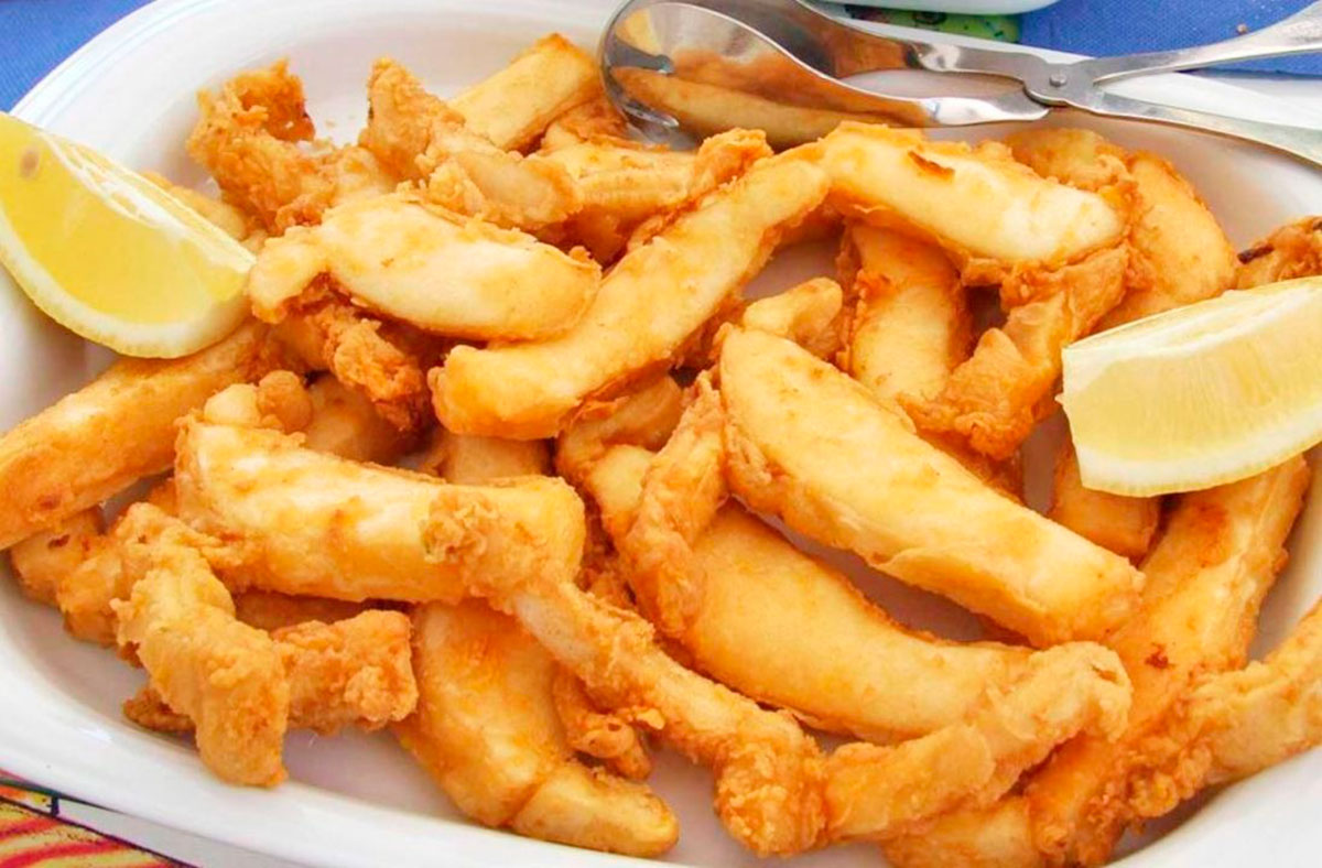"Tiras de choco frito," a popular Portuguese delicacy, features tender strips of cuttlefish ("choco") lightly battered and fried to golden perfection, offering a crispy, flavorful seafood experience often served with lemon and aioli.