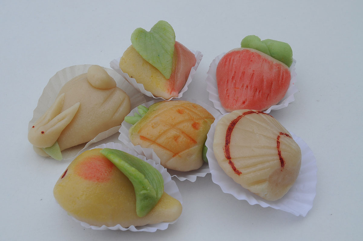 "Doces Finos," delicate Portuguese sweets, often feature a luxurious combination of almonds and egg yolks, meticulously crafted into intricate shapes and textures, showcasing the artistry and rich culinary heritage of traditional confectionery.