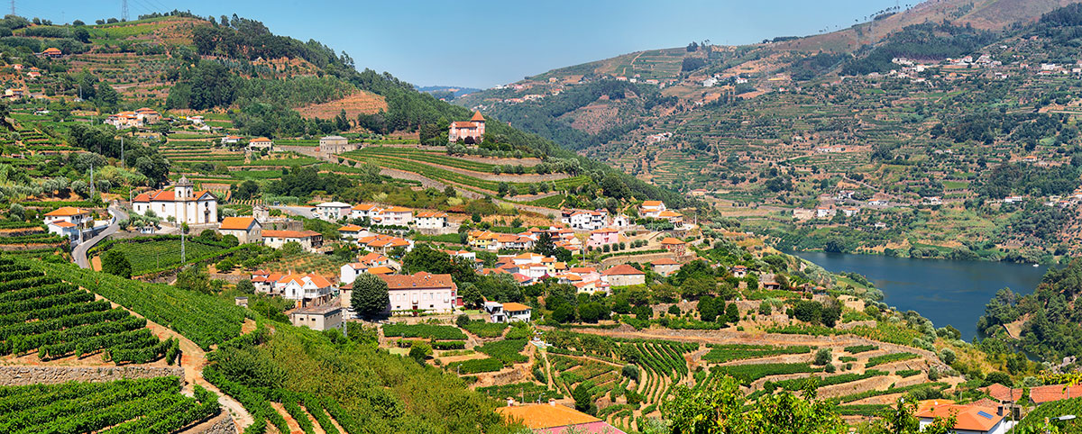 A traditional village in the Douro Valley, nestled amidst terraced vineyards and overlooking the winding Douro River, offers a glimpse into the region's authentic rural life, showcasing historic stone houses, local crafts, and the enduring traditions of Port wine production.