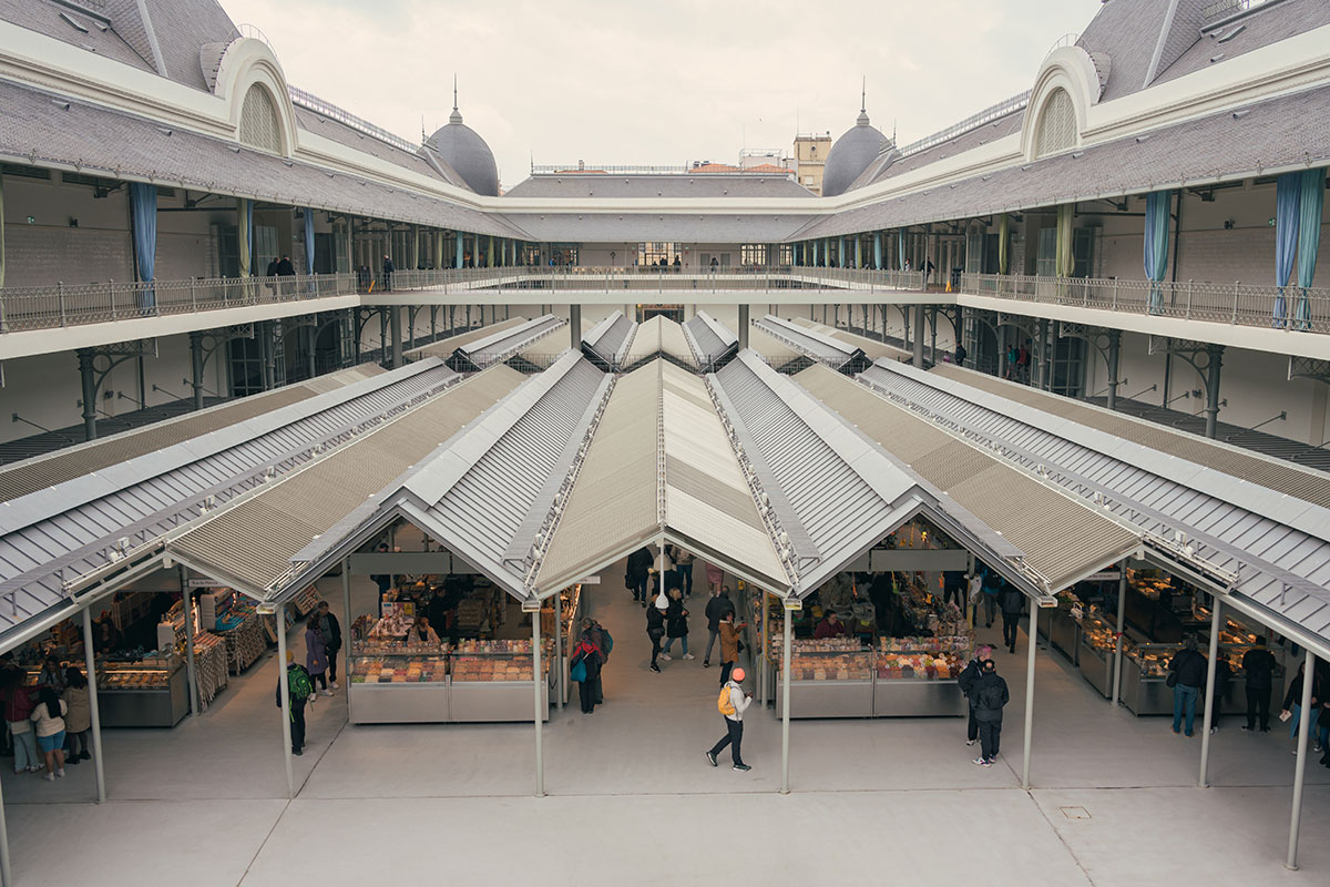 Mercado do Bolhão in Porto, Portugal, features a historic market building with stalls overflowing with fresh produce, seafood, and local goods, showcasing the vibrant atmosphere and traditional commerce of the city.