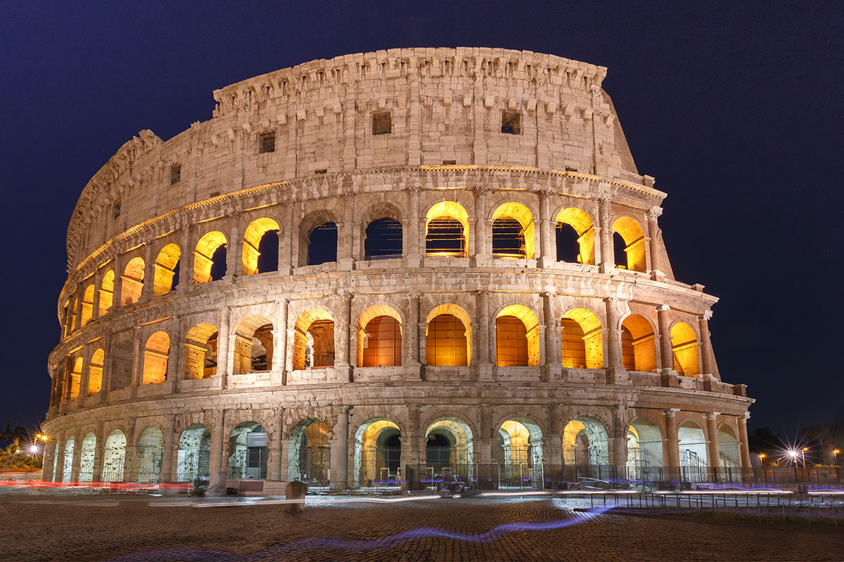 The Colosseum in Rome, Italy, stands as an ancient amphitheater with weathered stone arches and a central arena, showcasing its historical significance as a symbol of Roman engineering and entertainment.