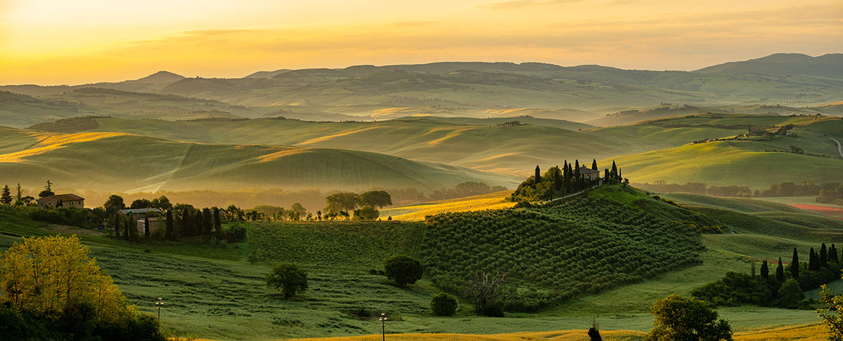 Chianti, in Tuscany, Italy, features rolling hills covered in vineyards, olive groves, and medieval villages, showcasing its scenic landscapes and renowned wine region known for producing classic Chianti Classico.