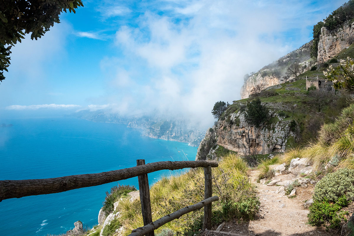 Hiking the Path of the Gods along Italy's Amalfi Coast offers breathtaking coastal views of dramatic cliffs, azure waters, and picturesque villages, showcasing the stunning natural beauty and scenic trails of this iconic region.