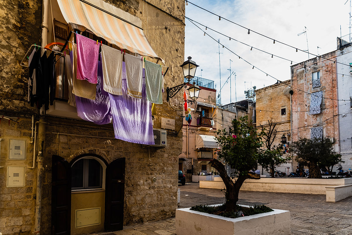 Narrow streets of Bari, Italy, feature cobblestone pathways and historic buildings, ideal for strolling and exploring the city's charming atmosphere during an Italian tour.