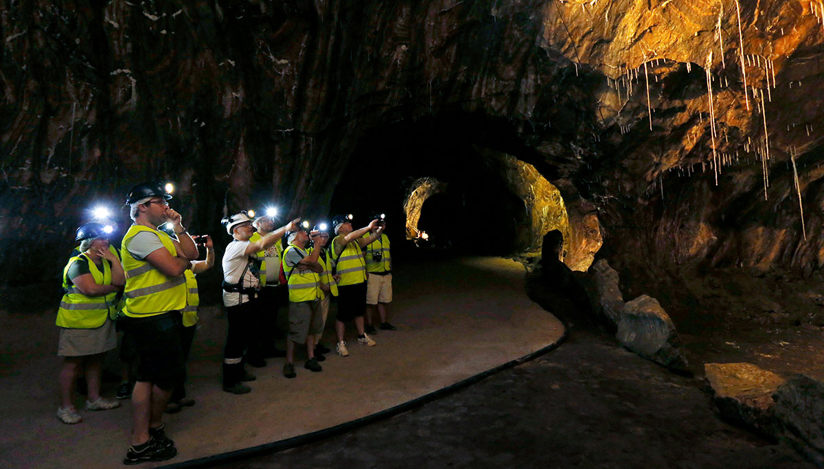 A guided tour of the Loulé salt mine in Portugal features illuminated tunnels carved into ancient rock salt deposits, showcasing the mine's geological history and the extraction process within a subterranean environment.