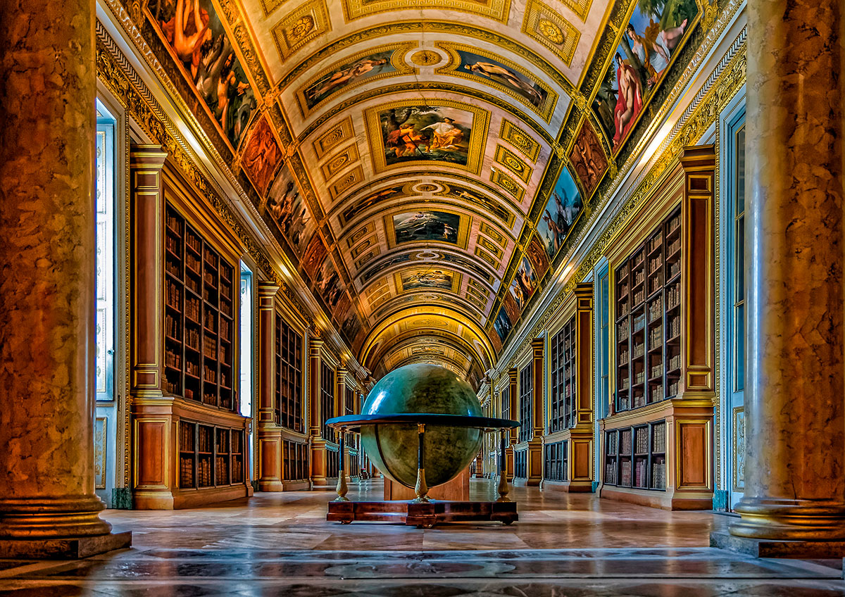 An opulent interior of the Château de Fontainebleau, showcasing richly decorated rooms with gilded details, ornate furniture, and historical artwork.
