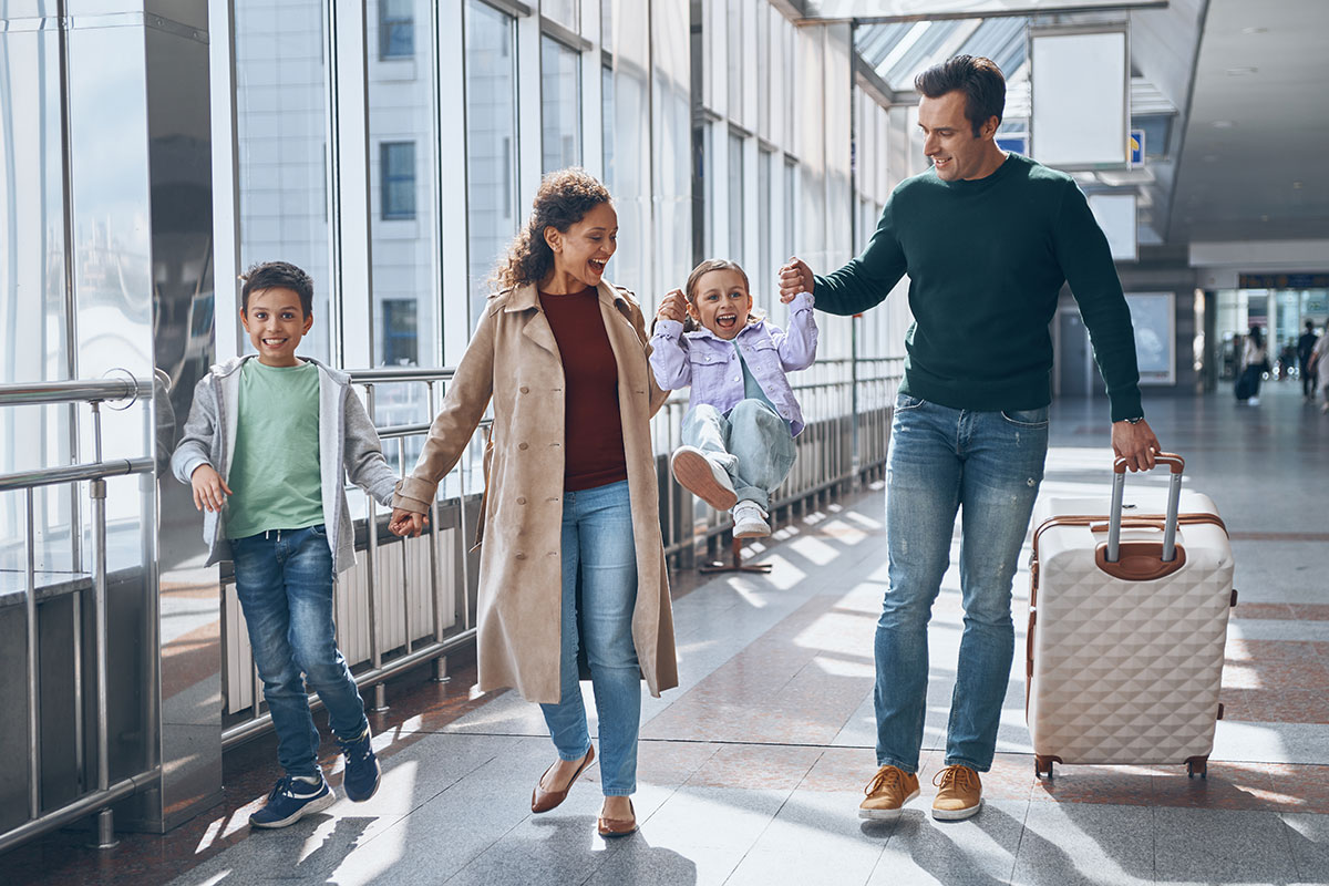 A smiling family at the airport, ready for a vacation