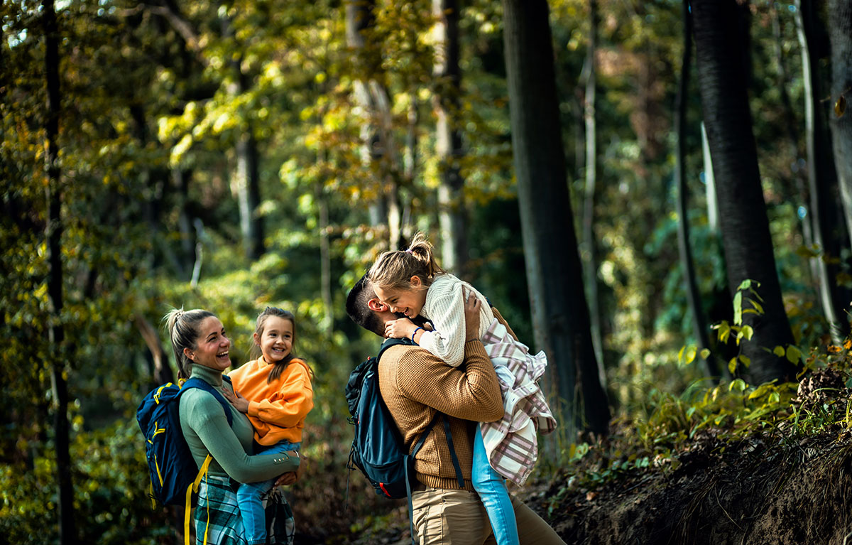 A family hiking on a scenic trail, bonding during their journey.