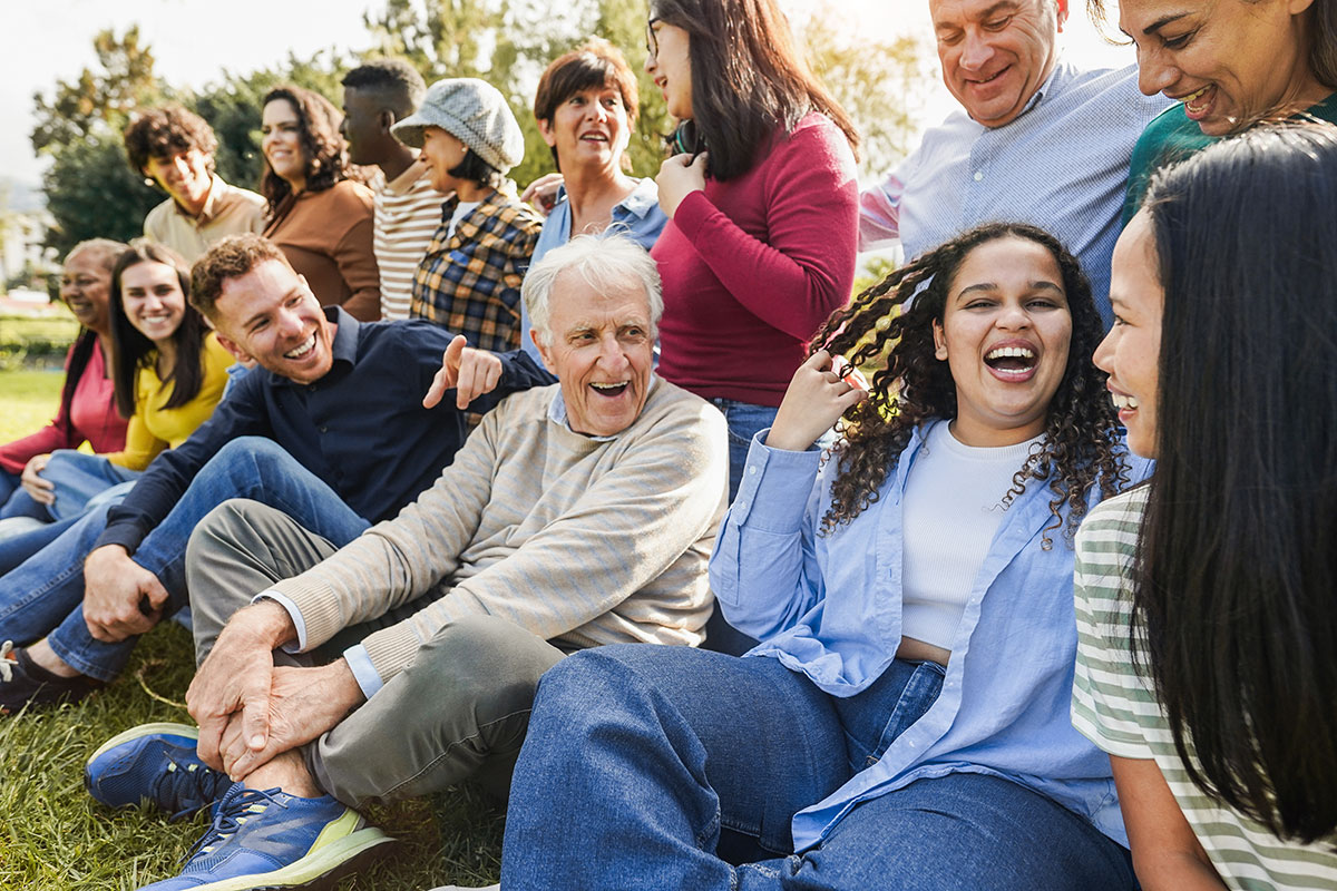 A happy family with children and grandparents enjoying a theme park ride together.