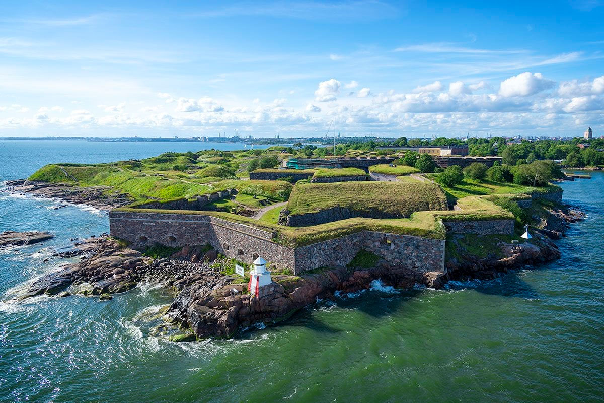 The historic Suomenlinna Fortress surrounded by the blue waters of the Baltic Sea.