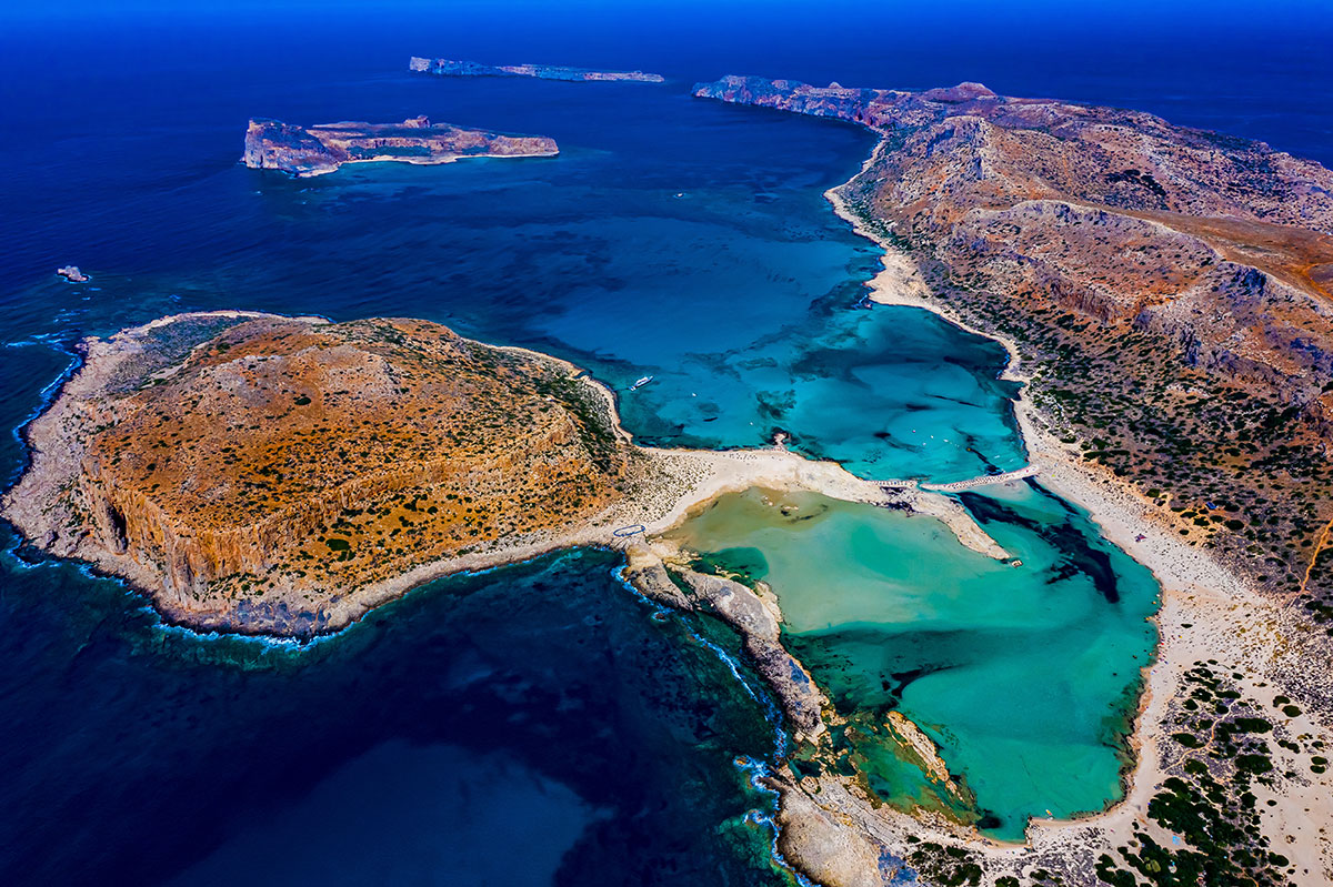 Aerial view of Balos Lagoon with turquoise waters and white sand.