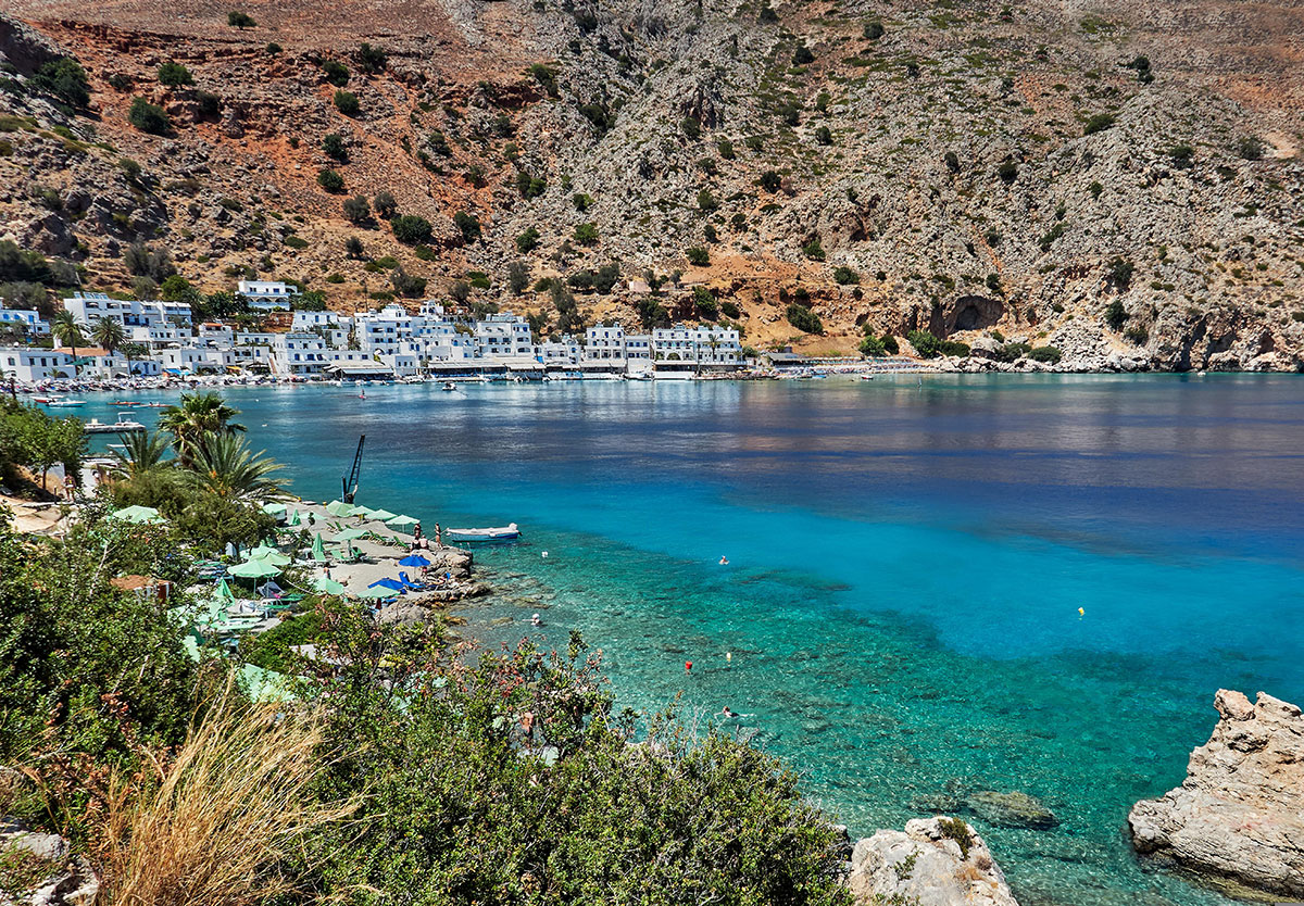 A serene view of Loutro village’s white-washed buildings by the turquoise sea