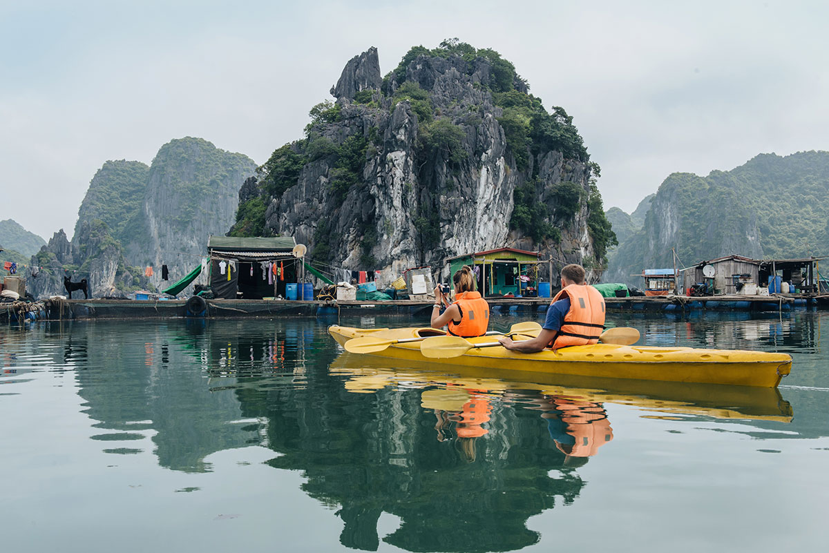Hạ Long Bay, Vietnam: Kayaking adventure near a floating village. Explore the UNESCO World Heritage Site