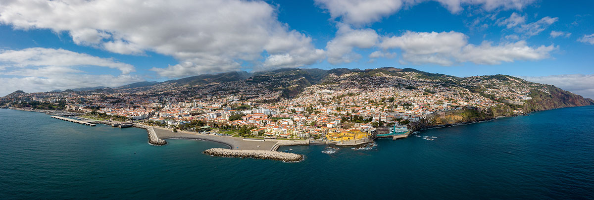 Aerial view of Madeira Island's dramatic coastline with cliffs and turquoise ocean