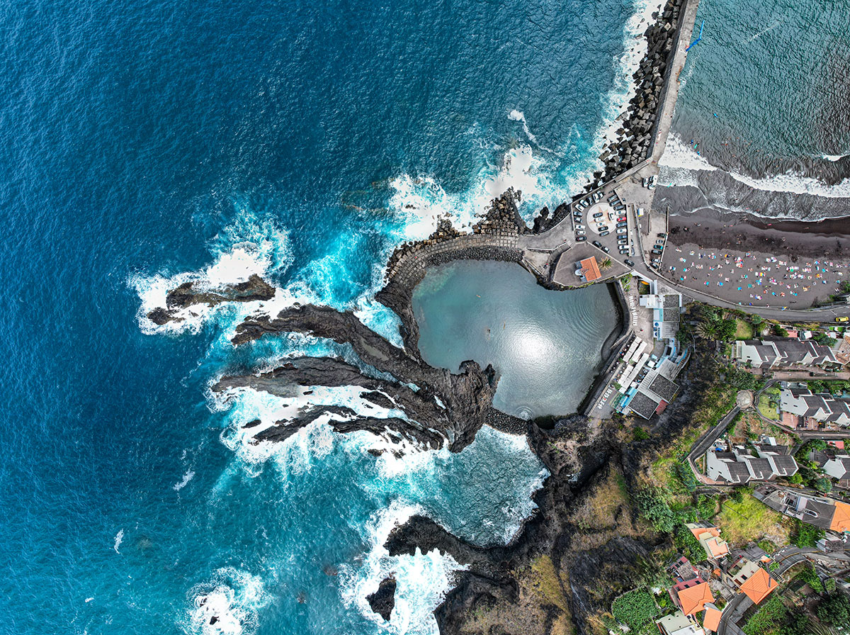 Natural volcanic pools filled with clear ocean water in Porto Moniz, Madeira