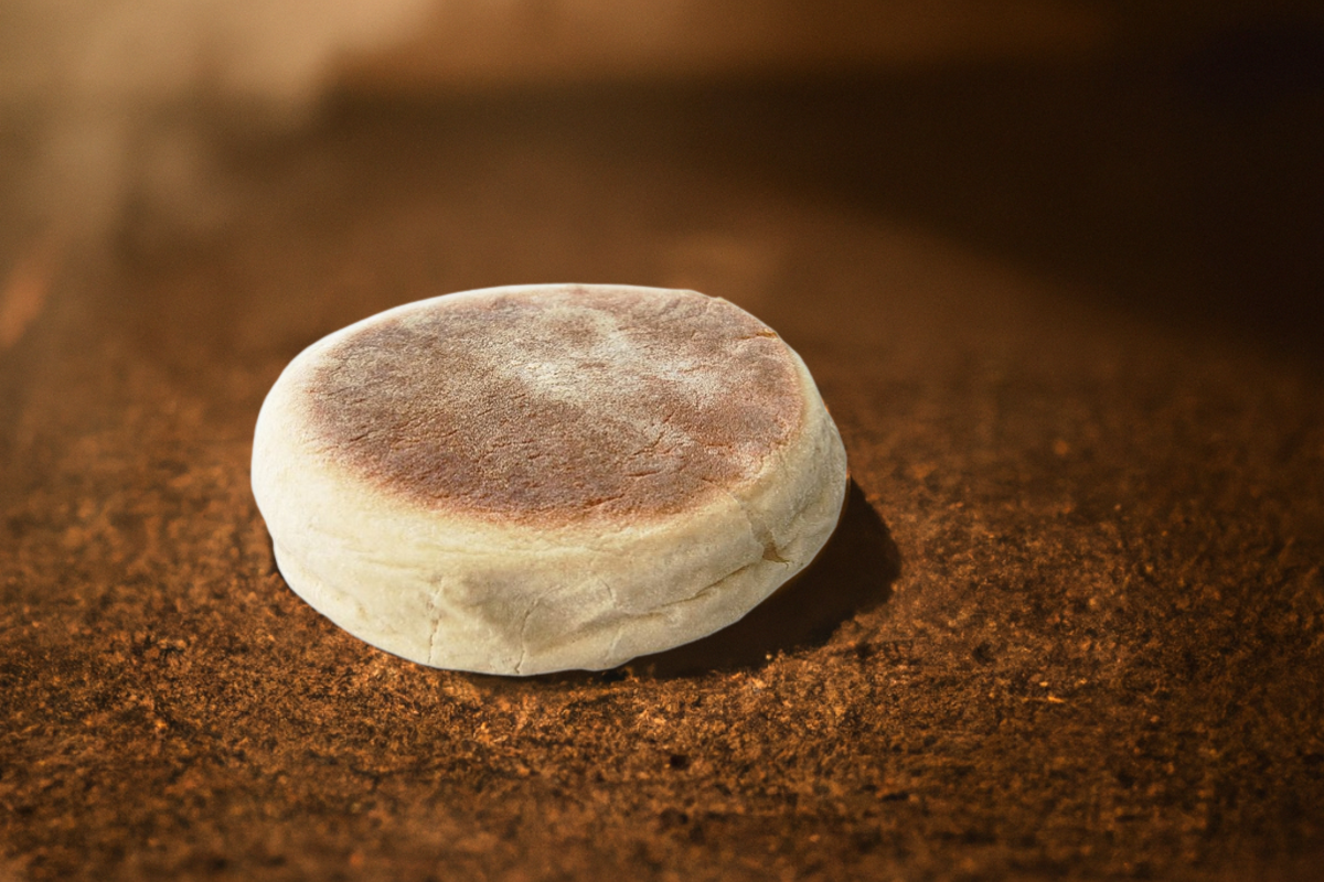 Fresh bolo do caco bread cooking on a flat basalt stone