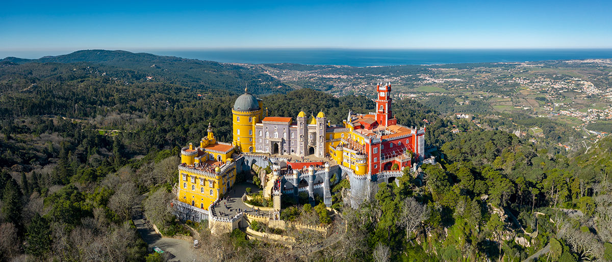 Aerial view of Pena Palace surrounded by Sintra forest