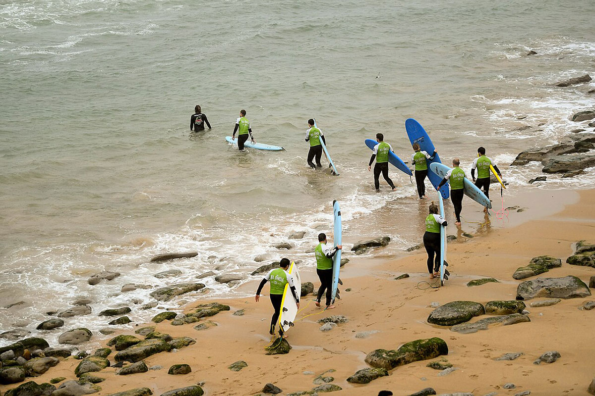 Colorful surfboards lined up at a beach in Ericeira, Portugal