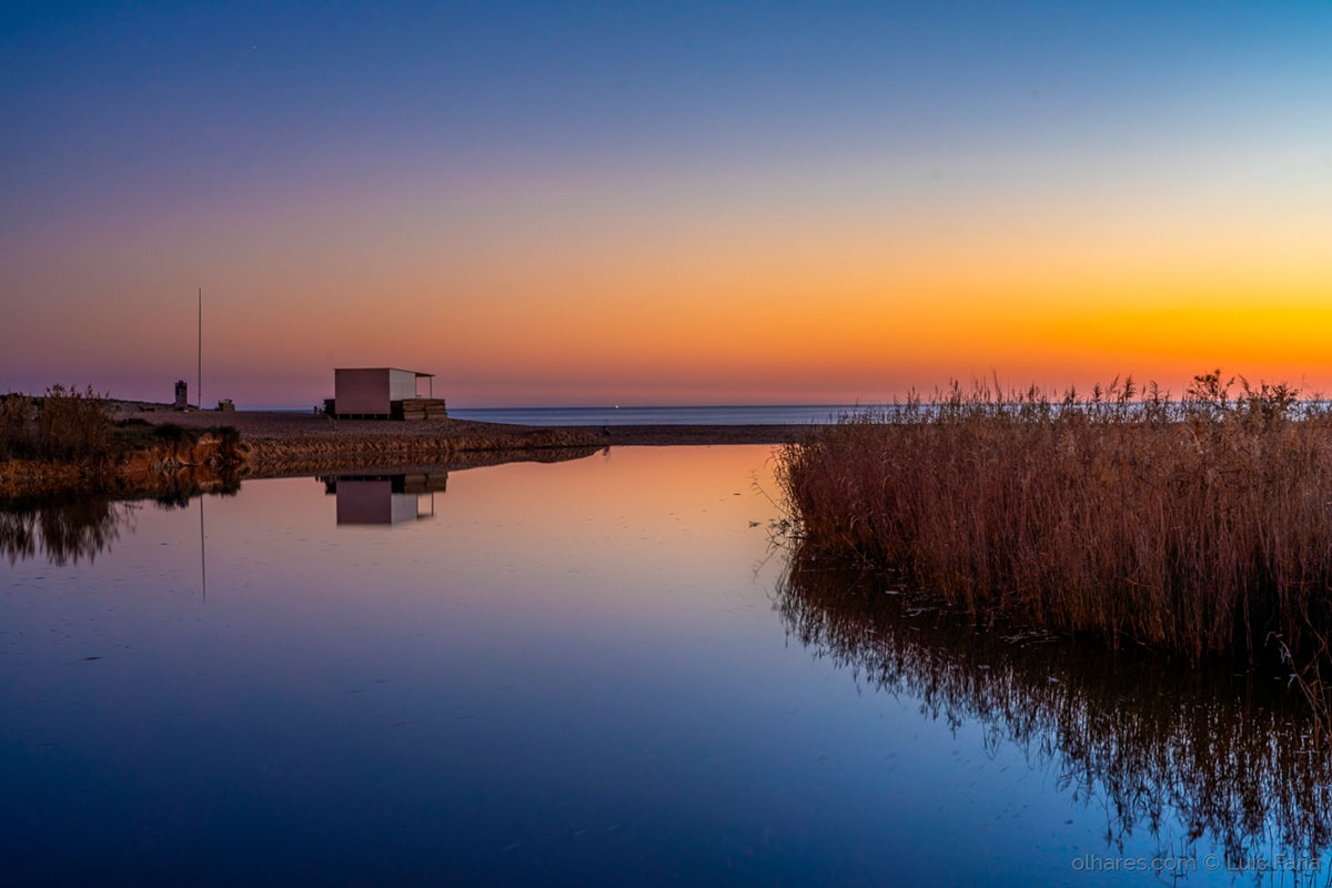 Sunset casting a golden hue over Lagoa dos Salgados.