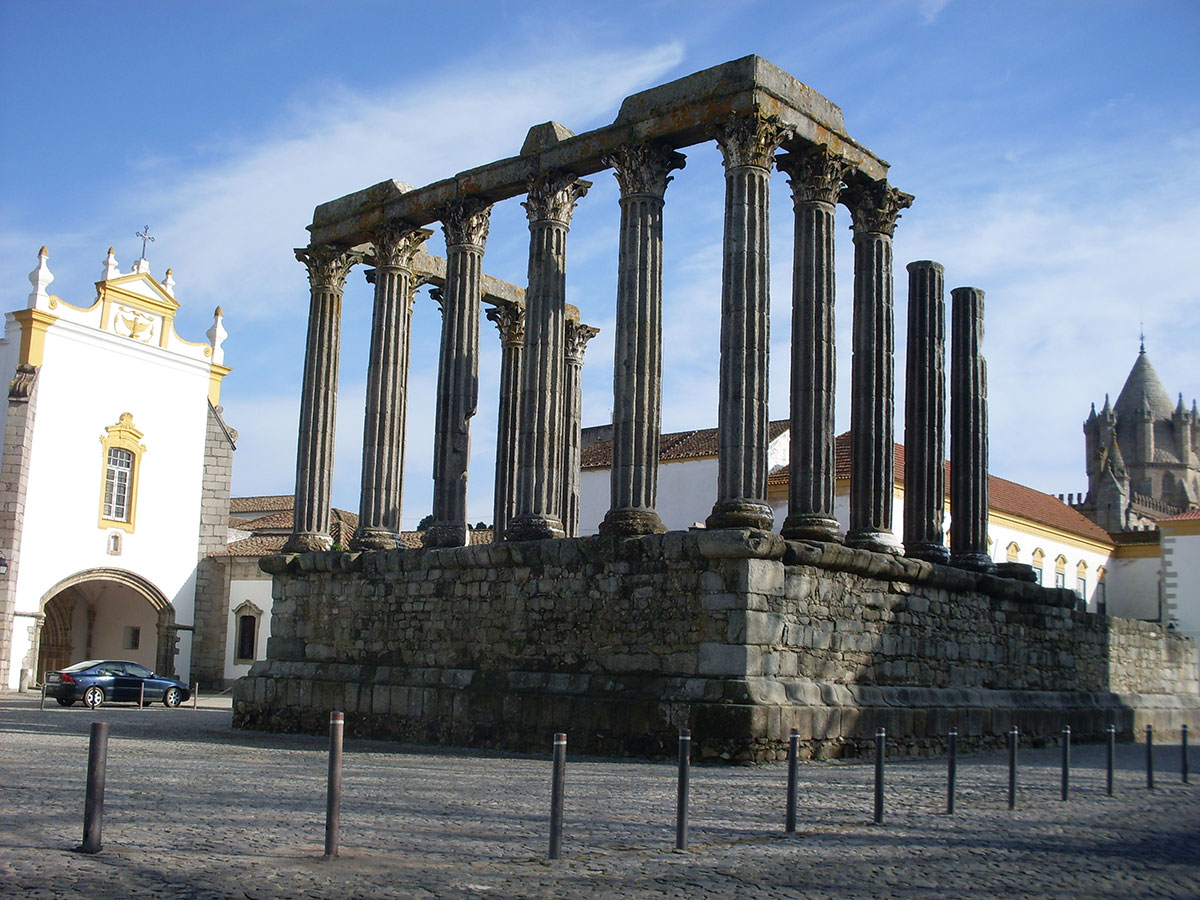 Roman Temple of Évora illuminated at dusk.