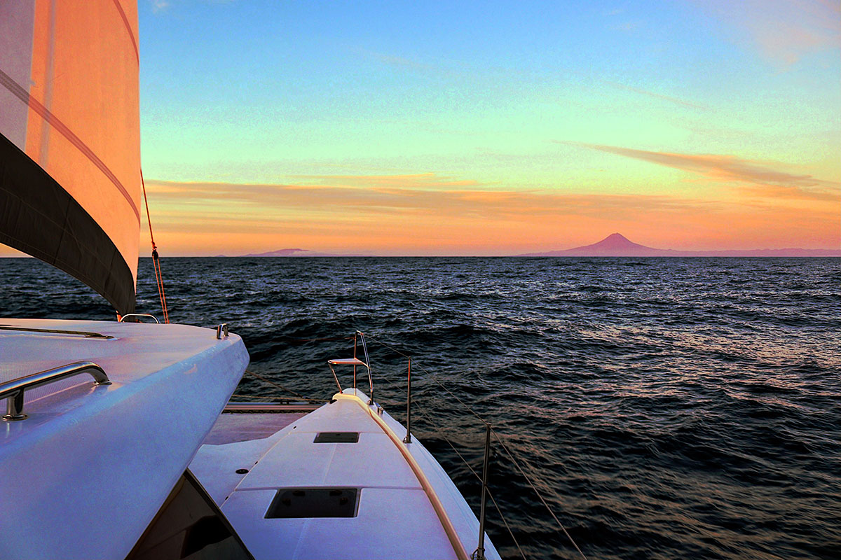 Beautiful sunset over the Atlantic Ocean in the Azores with a fishing boat.