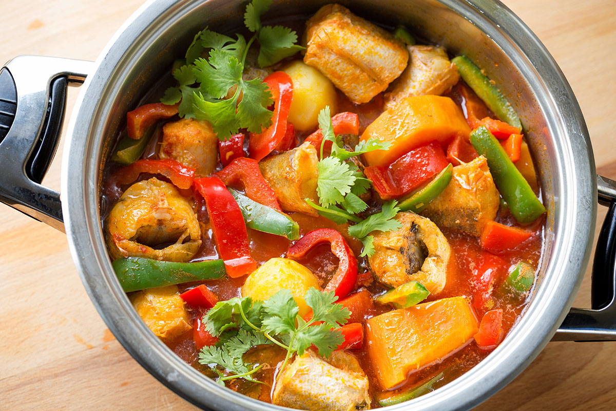 Hearty Caldeirada de Peixe with assorted seafood and vegetables.