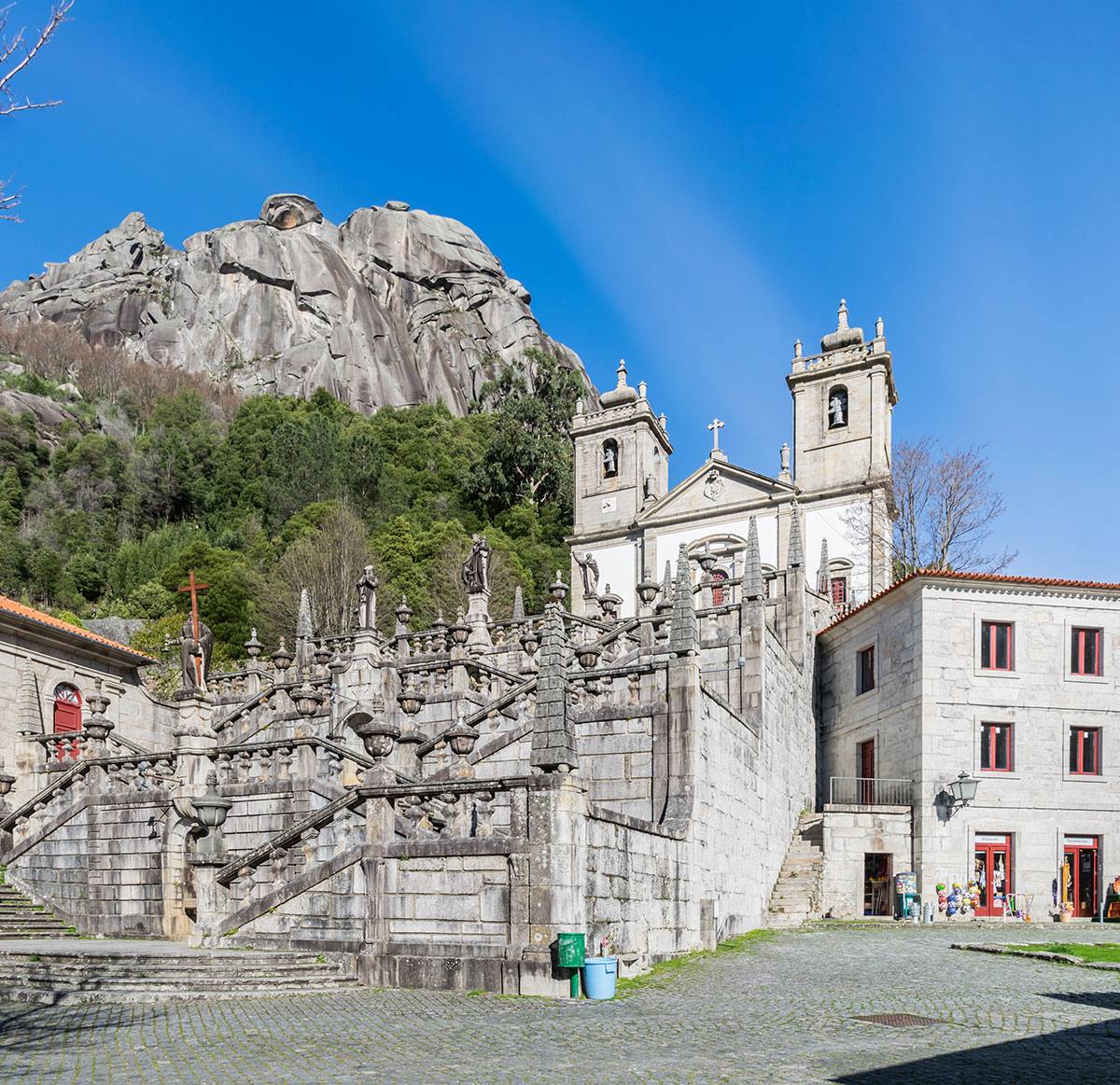 Front view of the Sanctuary of Nossa Senhora da Peneda, with its grand staircase and mountainous backdrop in Peneda-Gerês National Park.