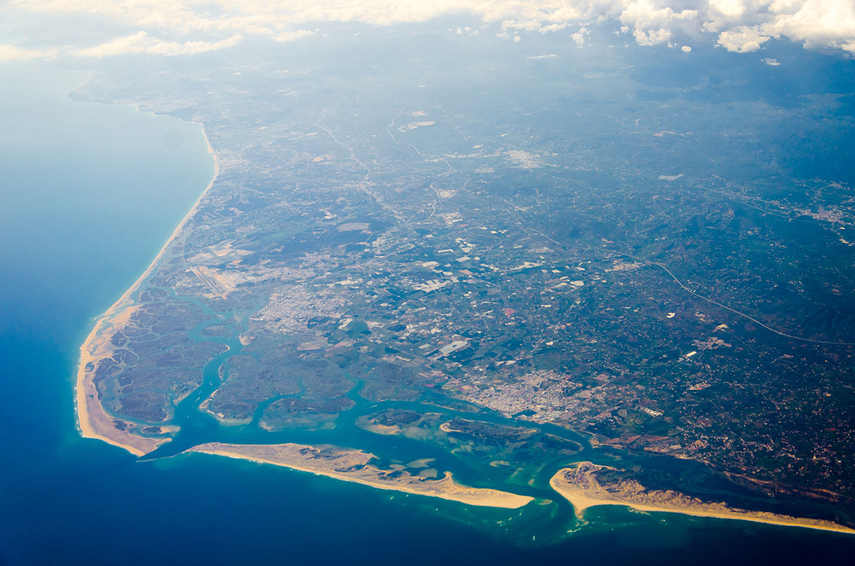 Aerial view showcasing the diverse landscapes of Ria Formosa Natural Park, including lagoons, islands, and marshlands.